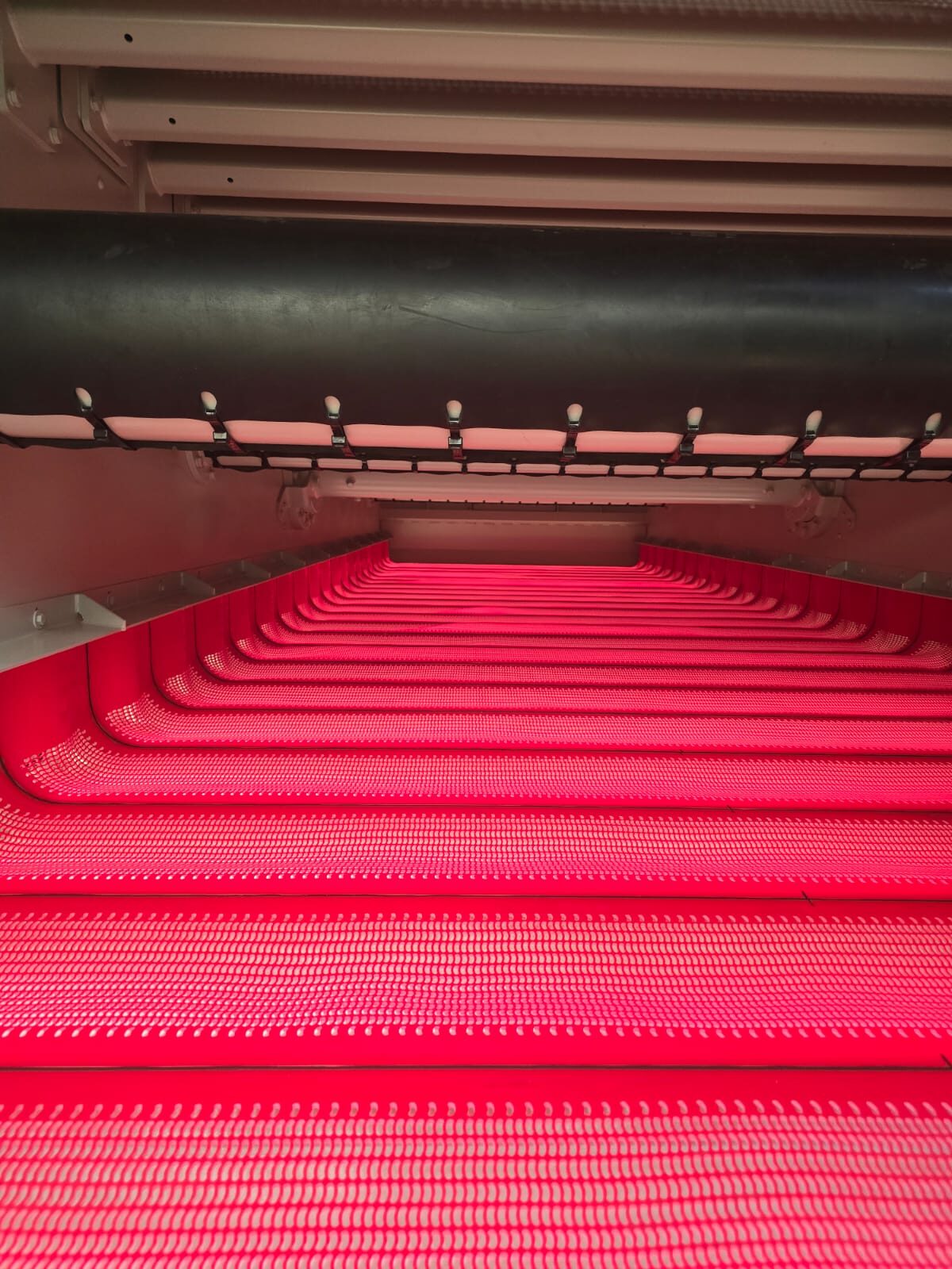 Red flip-flow screen decks viewed along the machine