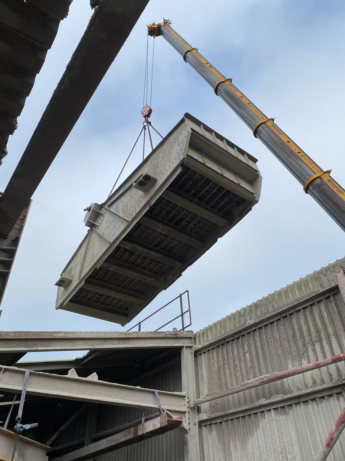 A screen lifted into position during installation