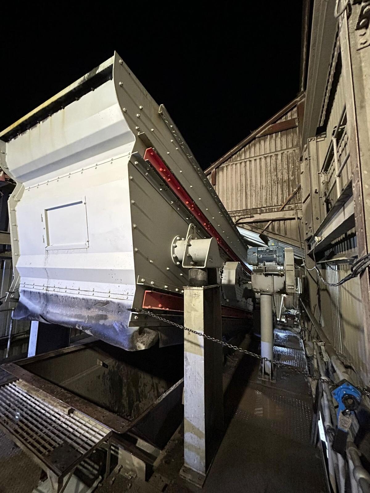 A screening line running at night